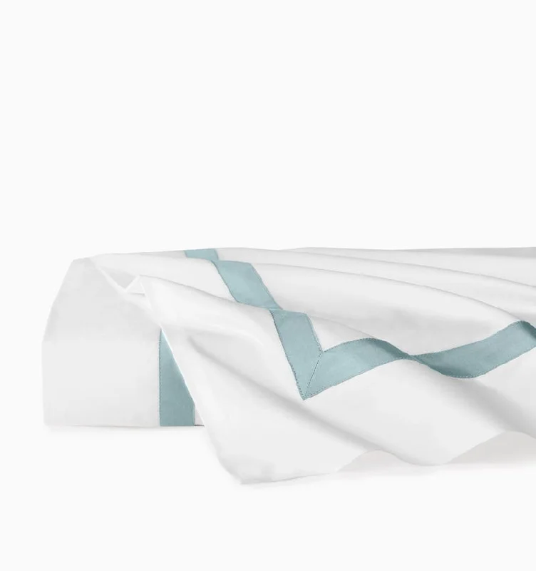 Embroidered duvet covers with intricate needlework for a luxurious touchEstate Bedding in White and Poolside by Sferra